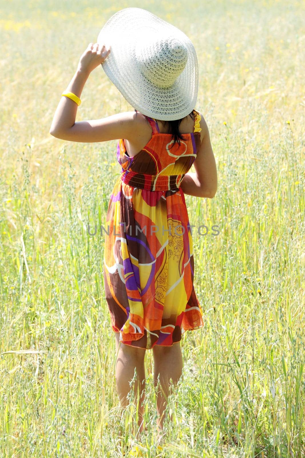 Young happy woman in green grain field