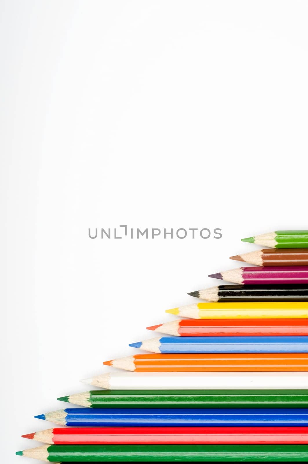 Assortment of coloured pencils with shadow on white background