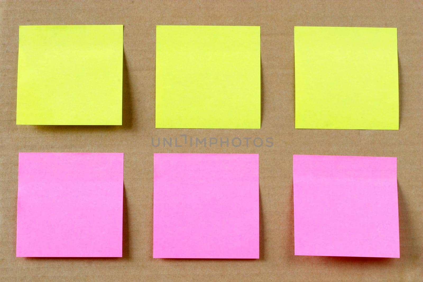 Six colored (yellow and pink) notes on cardboard