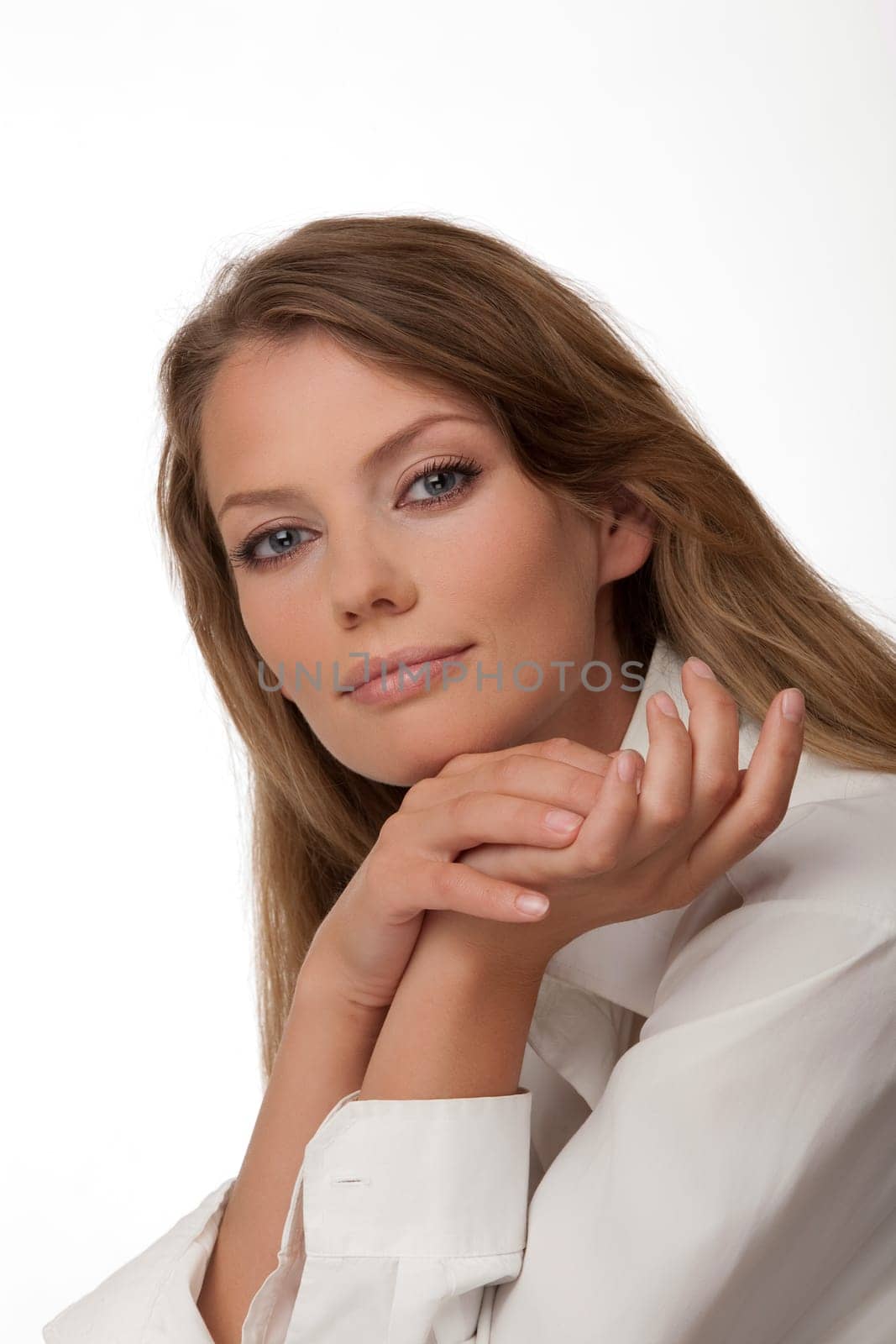 Portrait close up of the young woman of the European type with blue eyes, on a white background