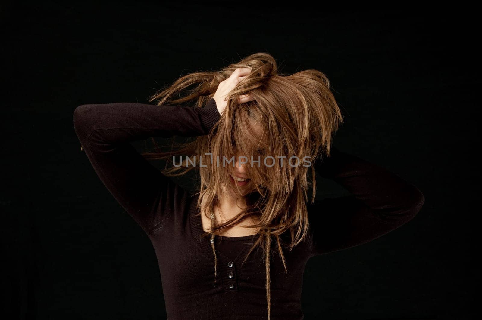 Hair flick against black background