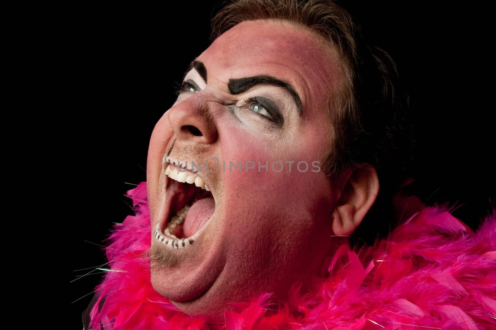 Clown yelling against black background