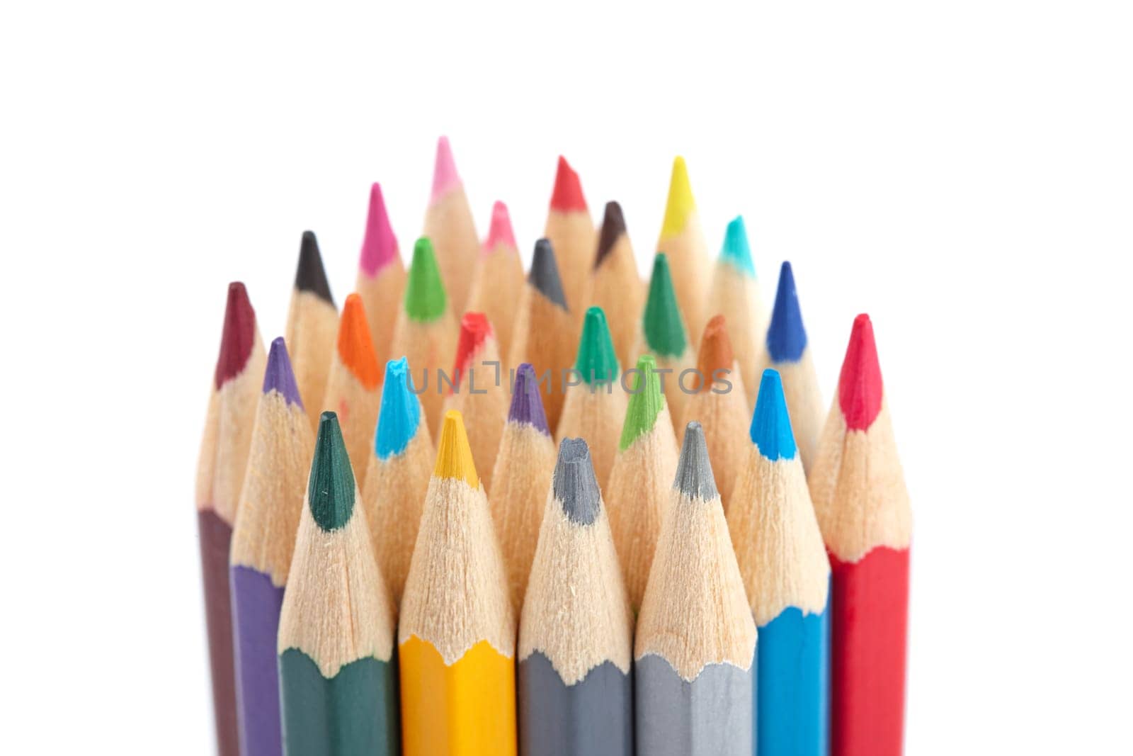 Assortment of coloured pencils isolated on white background. Shallow depth of field