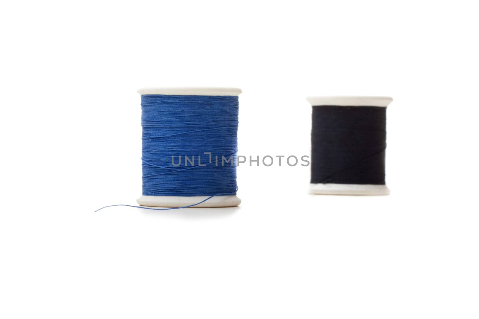 two rolls of sewing cotton isolated on white