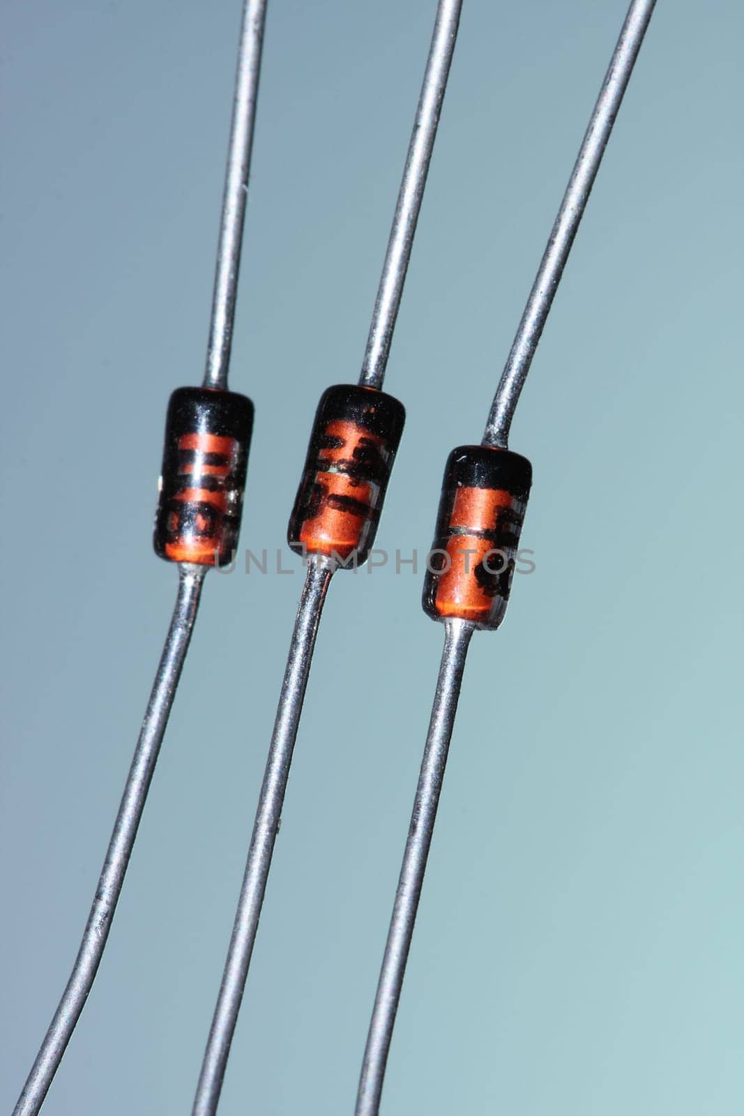 Three zener diodes against a blue-green background.