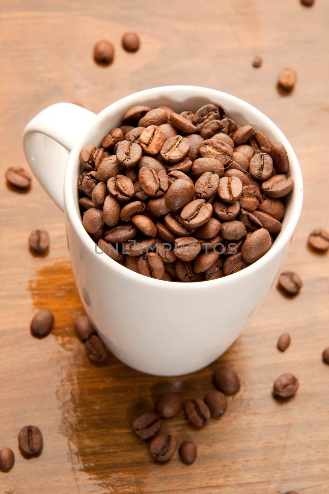 Arabica espresso beans in a white cup