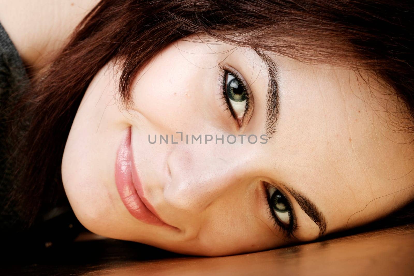 Portrait of a happy beautiful woman with green eyes.