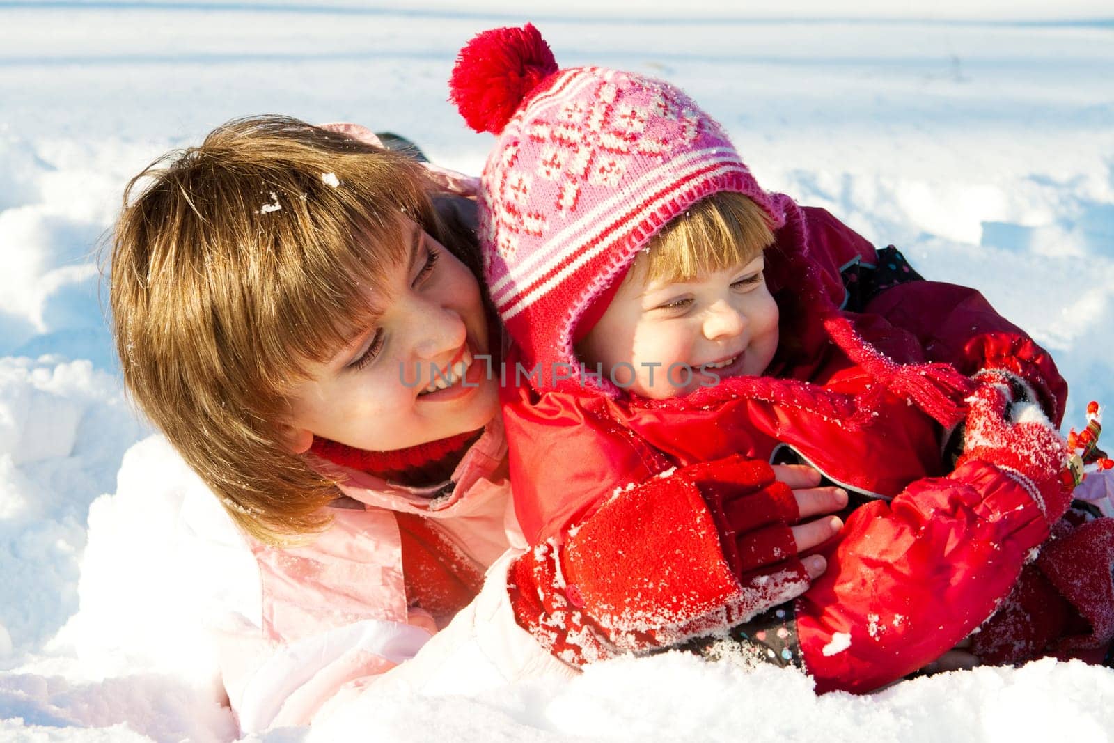 Mother and daughter playing in the snow