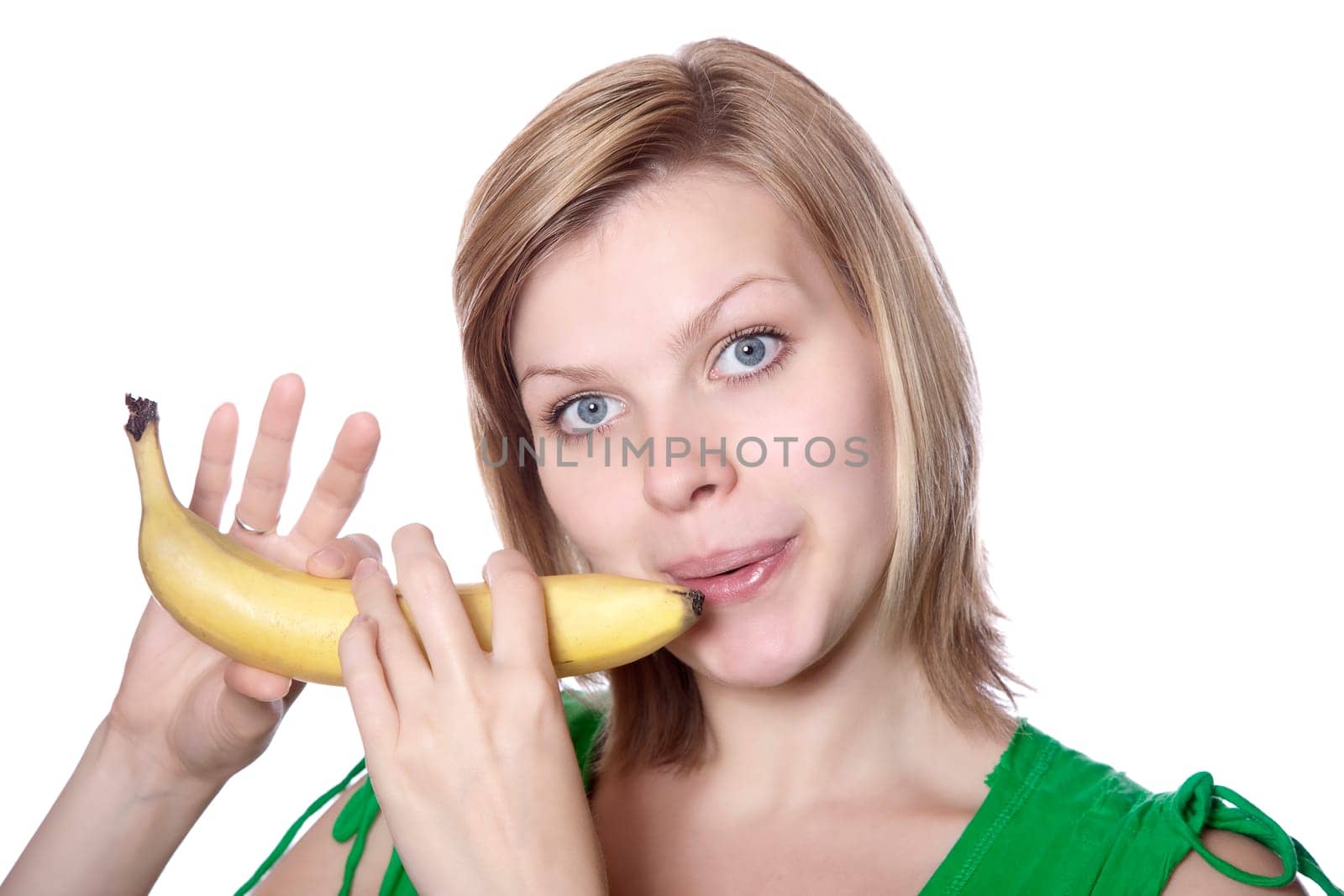 beautiful blonde young girl playing on a banana like a flute, isolated on white