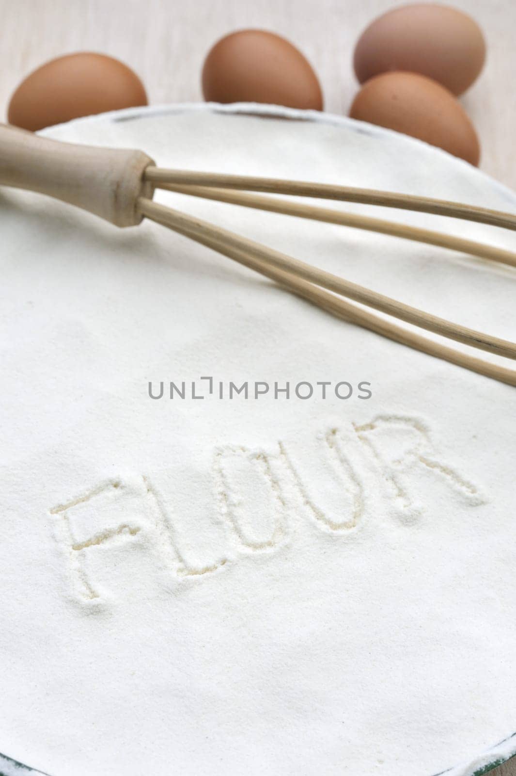 Word "flour"" handwritten in flour"