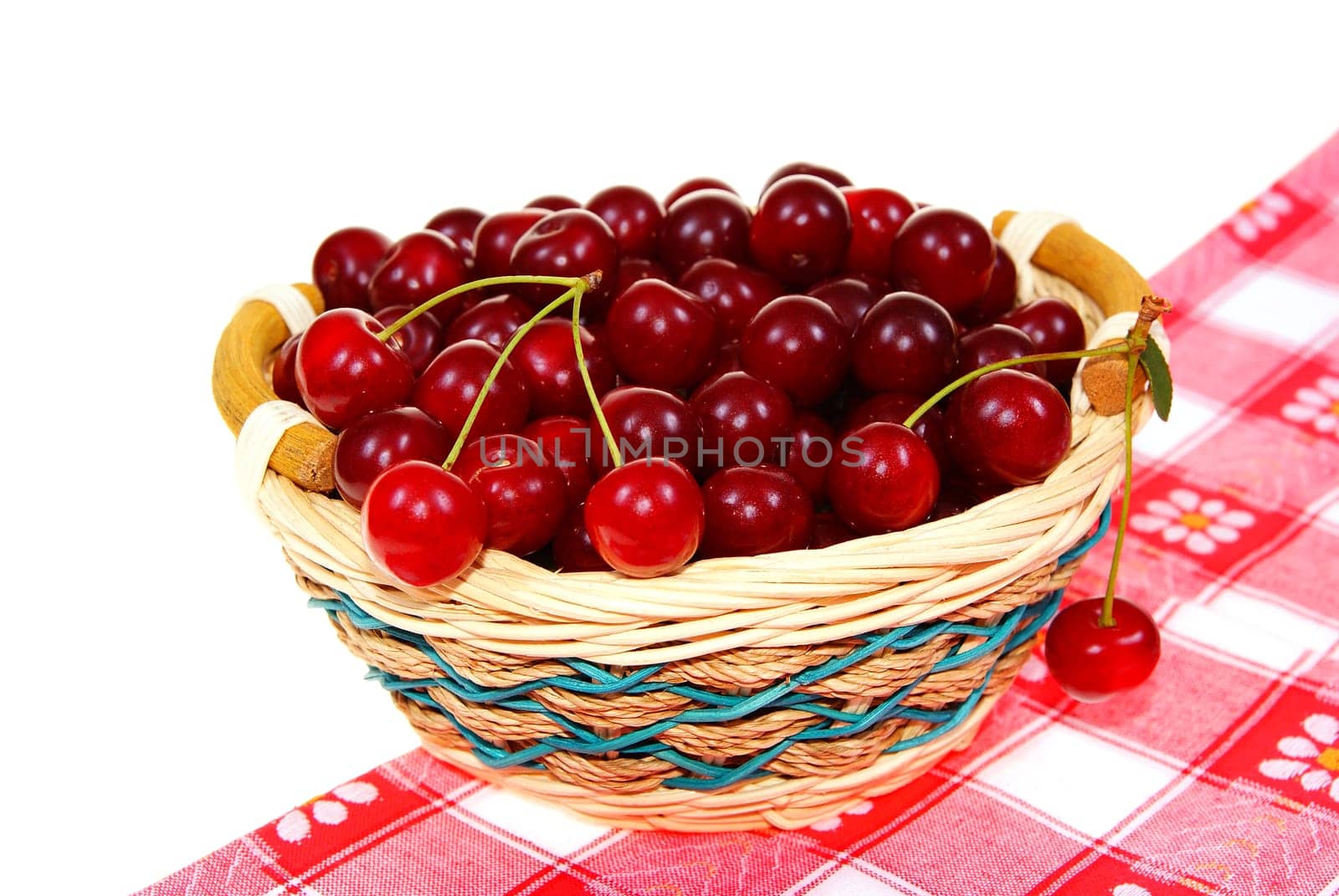 ripe cherry  in wicker on white background