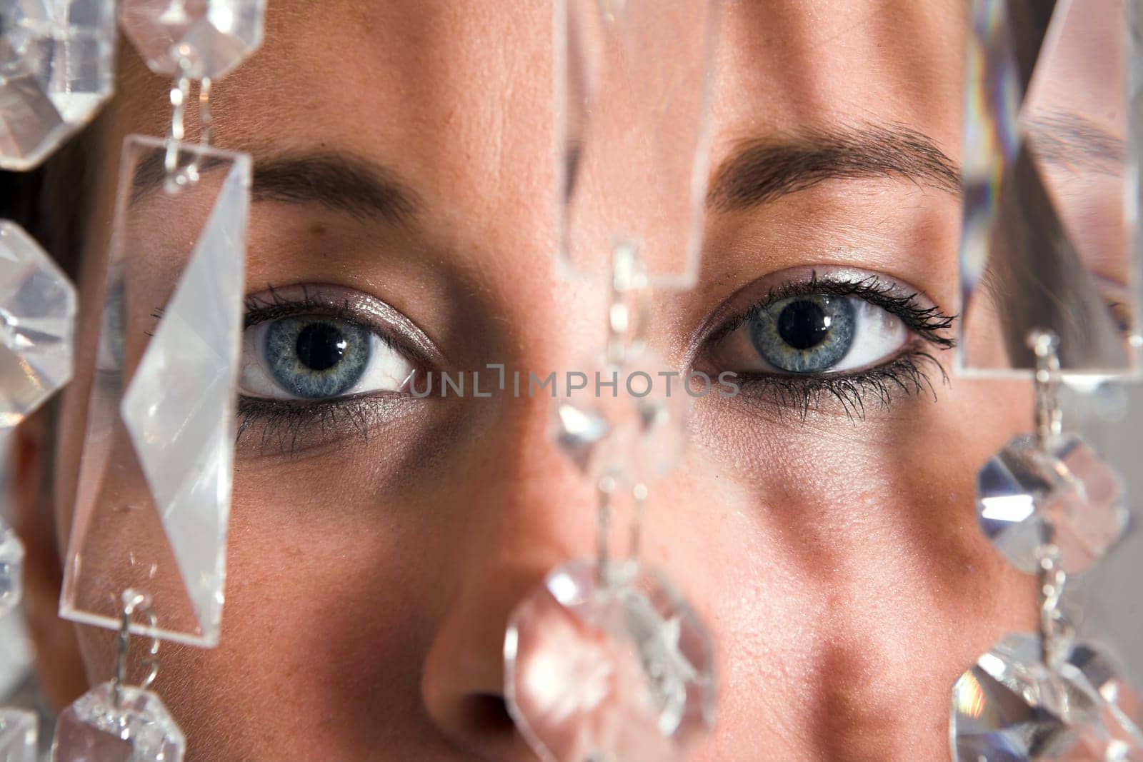 Young attractive Woman eyes closeup with glitter chain