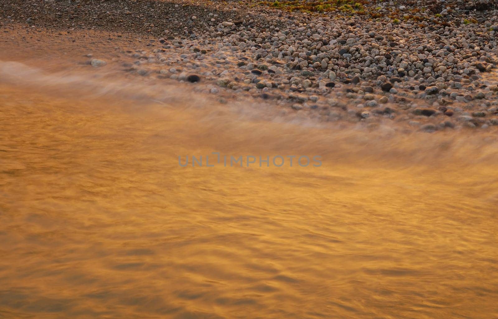 the evening surf coloured by sun set