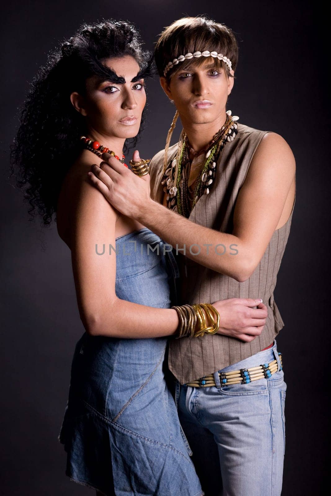 Young couple posing on black background