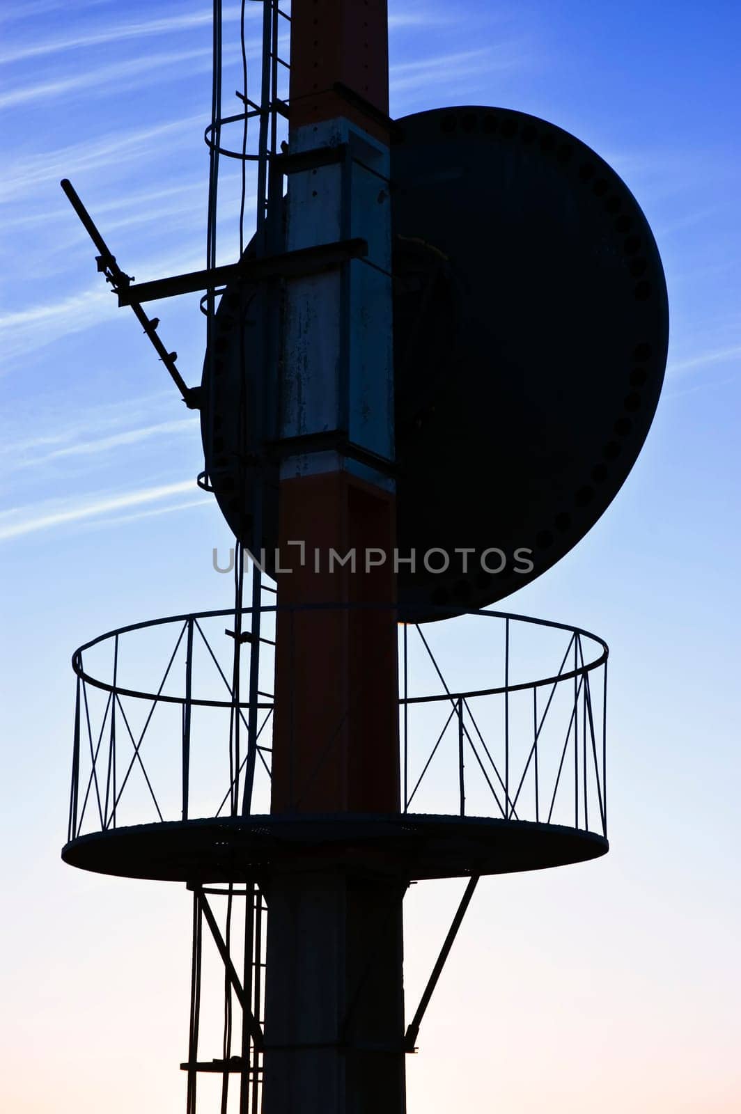 Telecommunications antenna against a clear blue sky