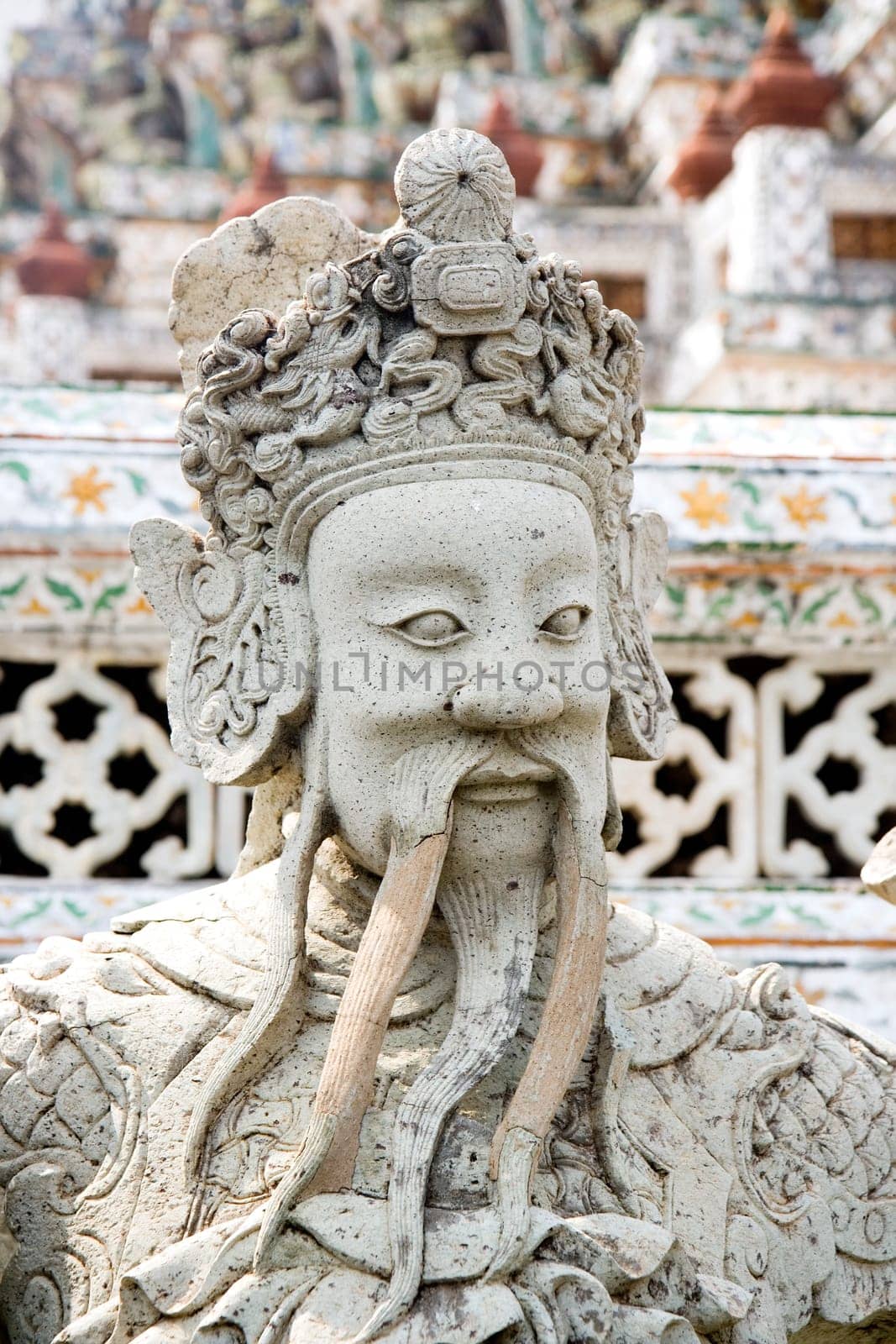 Guardian statue at the Buddhist temple of Wat Arun in Bangkok, Thailand.