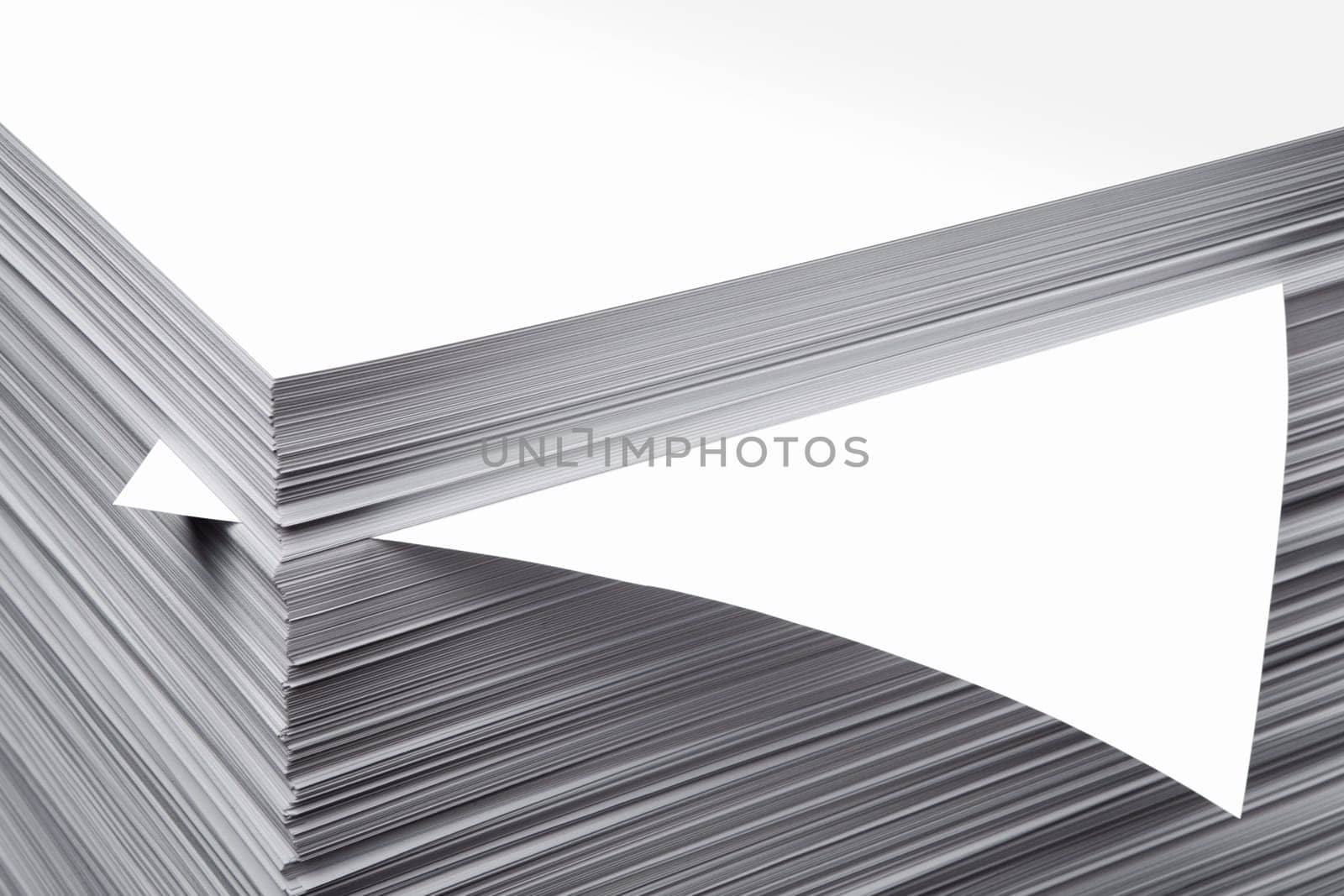 The white pure leaf which is sticking out of a pile of a paper