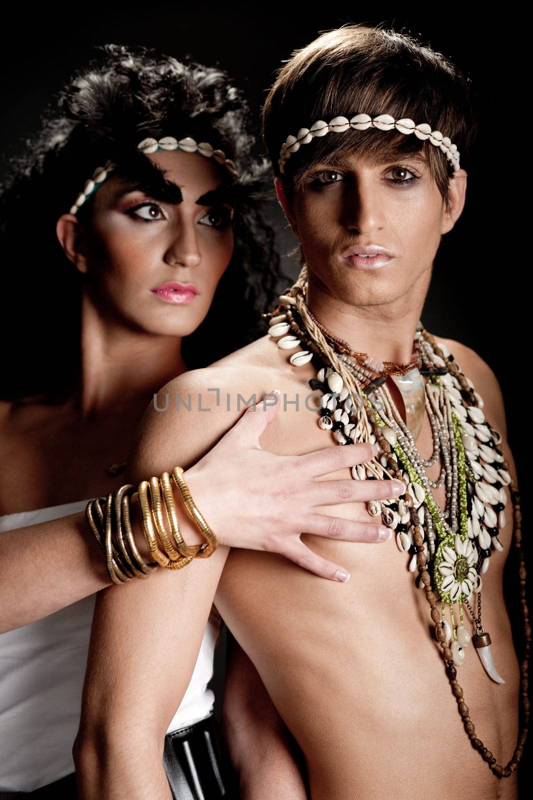 Couple in love posing against black background