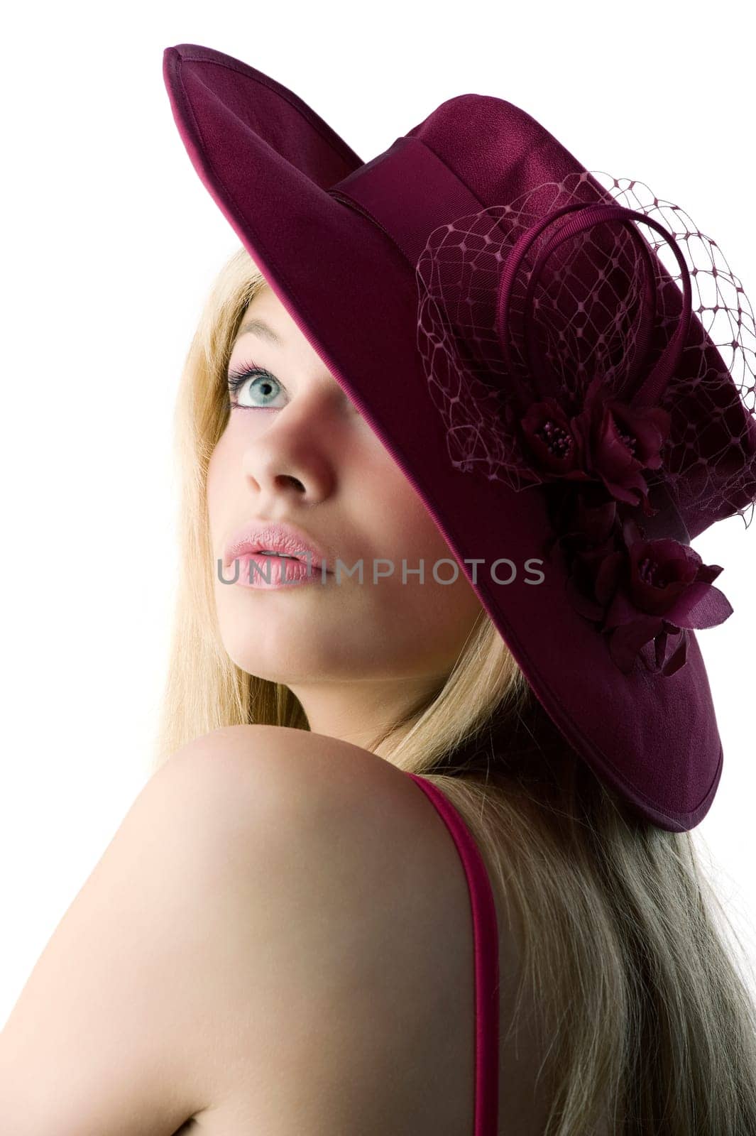 beautiful blond woman with a red hat and a red top making face and smiling