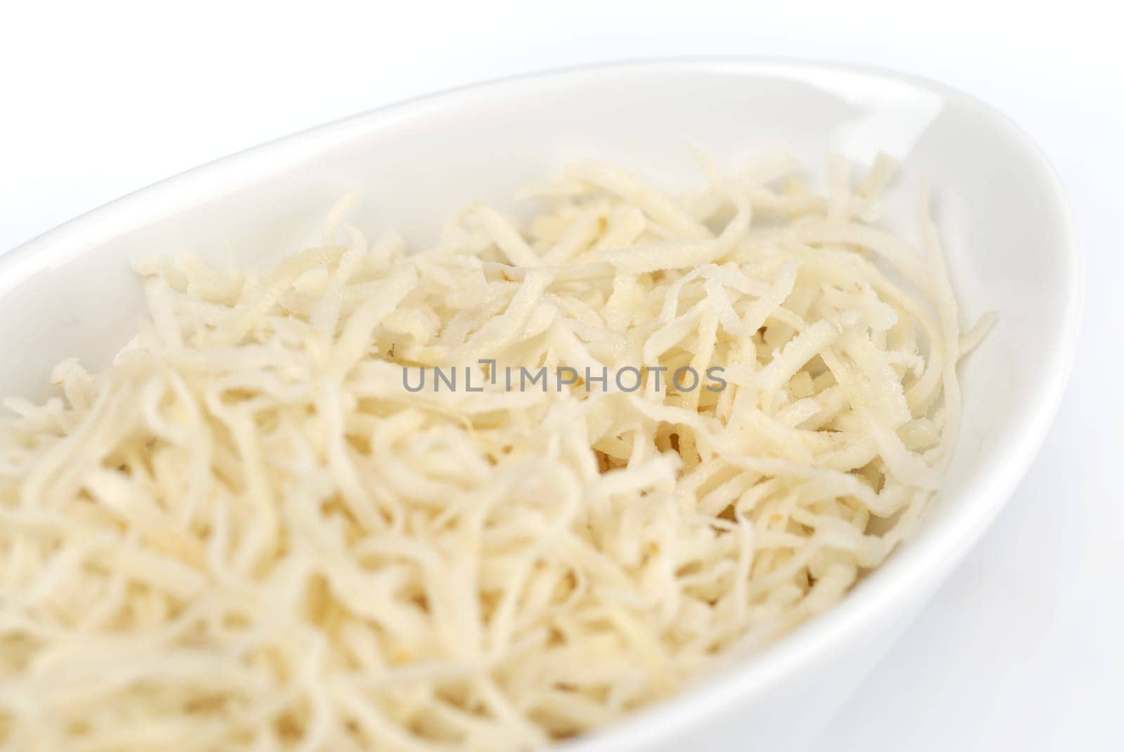 Grated cheese on the white plate