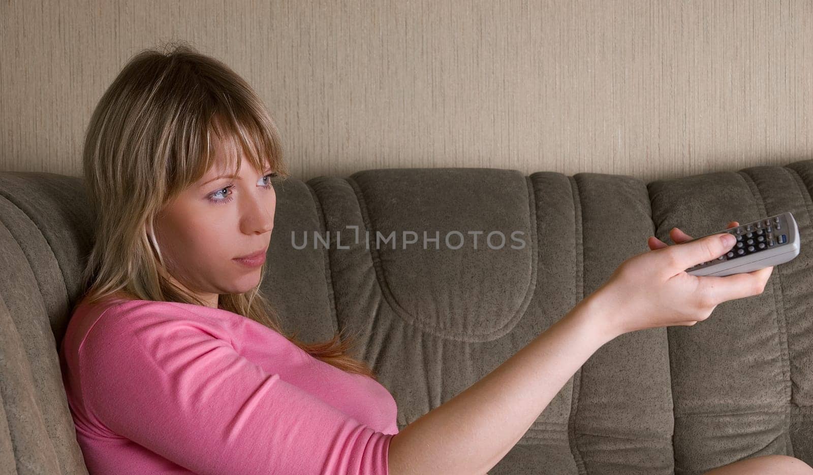Girl sitting on the sofa and watching tv