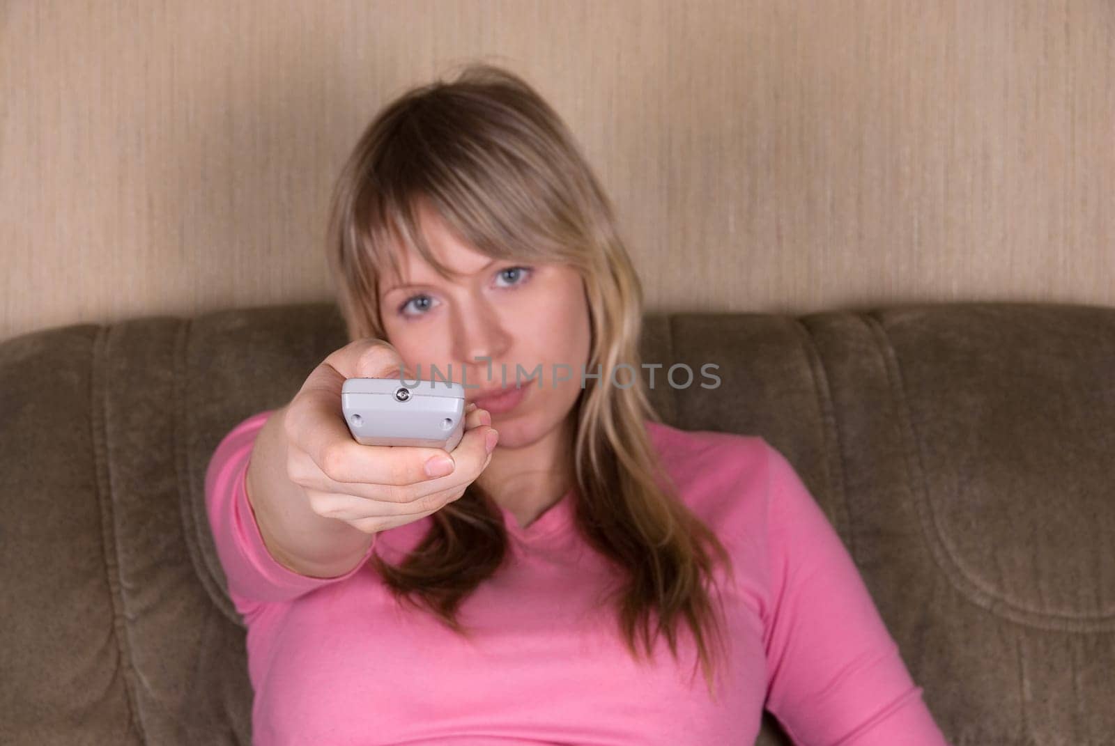 Woman sitting on the sofa and watching tv