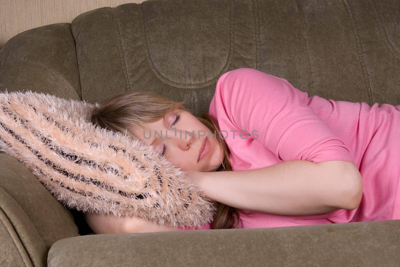 Sleeping pretty woman at sofa