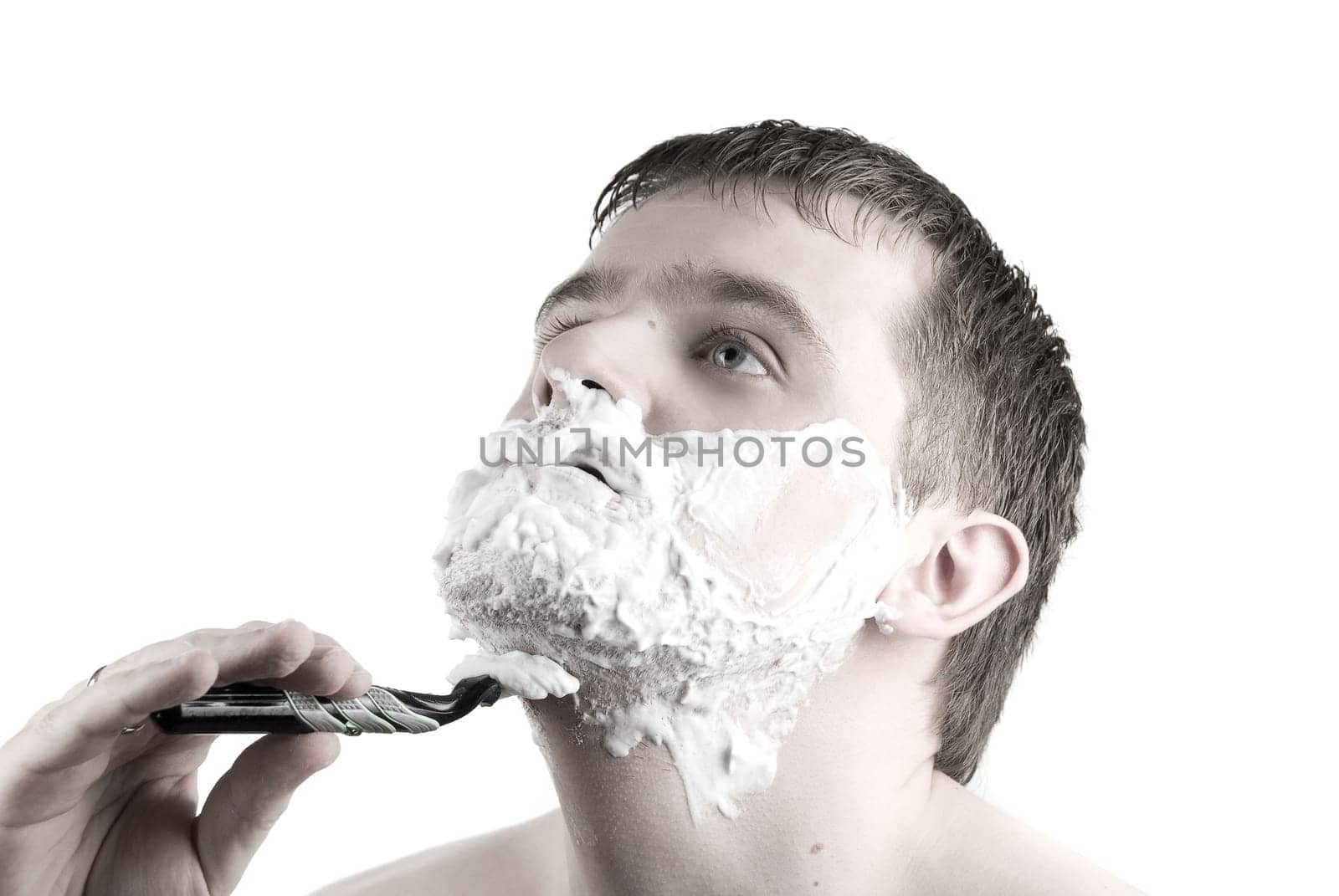 Shaving  Man with razor and foam on white