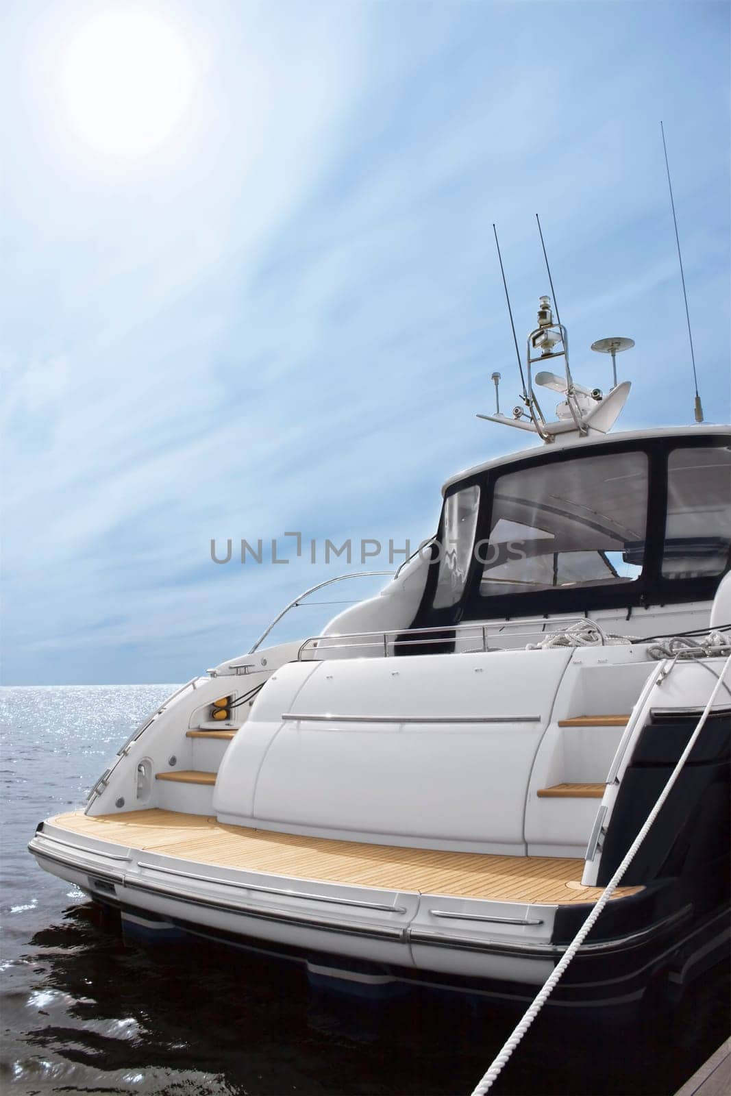 Rear view of white luxury yacht, blue sky and sea