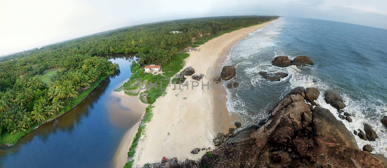 A beautiful landscape of beach having palm tree and house