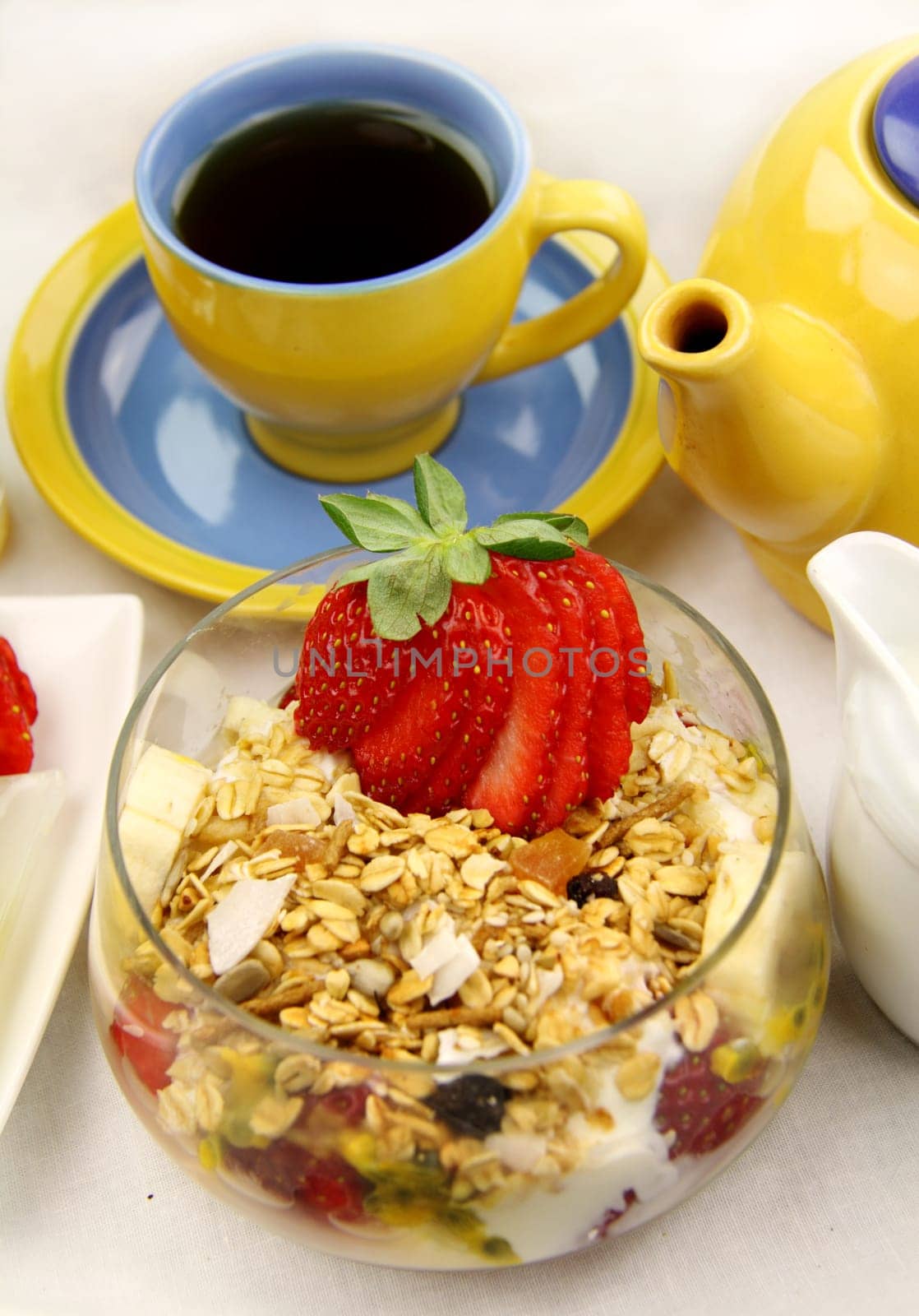 Healthy and hearty breakfast of muesli, strawberries and tea.