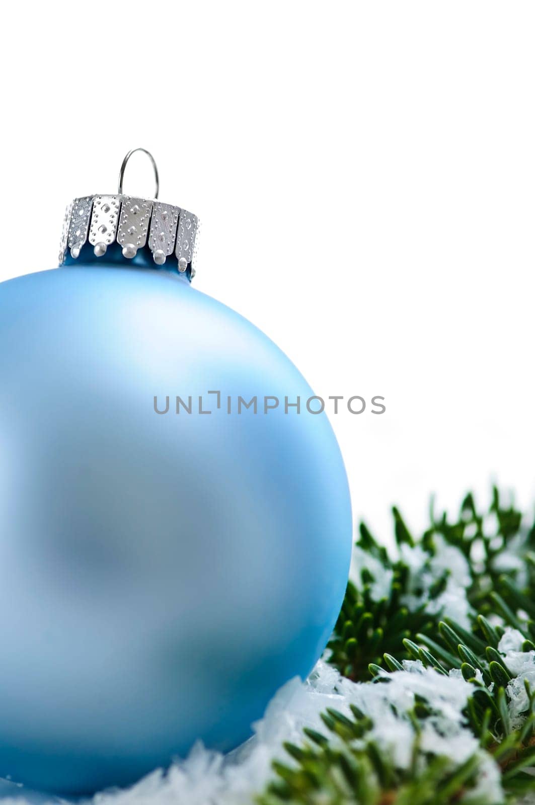 Blue Christmas decoration in snow with pine branches
