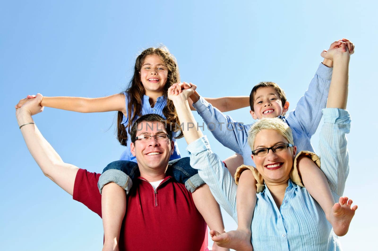 Happy family having fun giving shoulder rides
