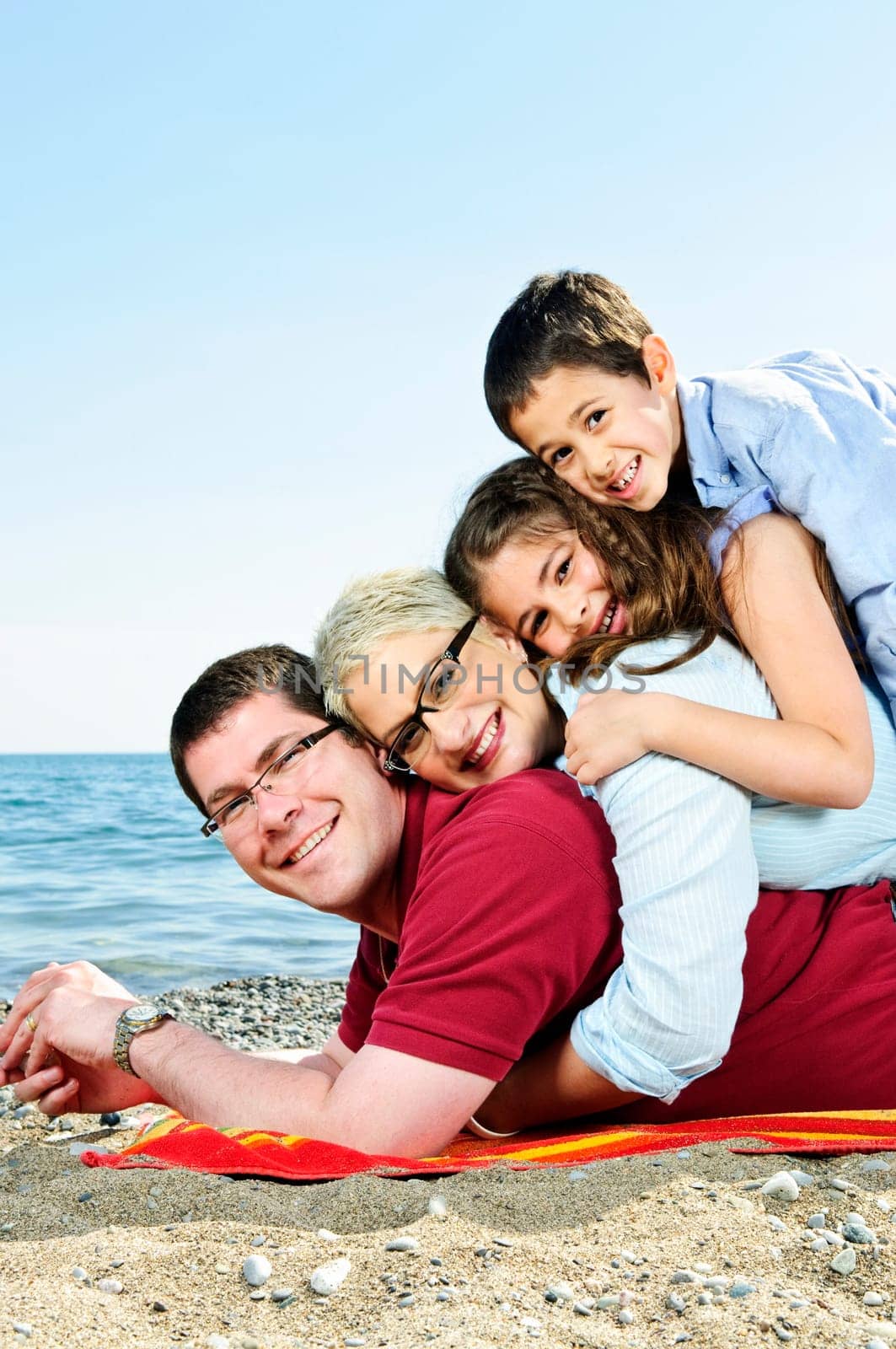 Portrait of a happy family having fun on a beach