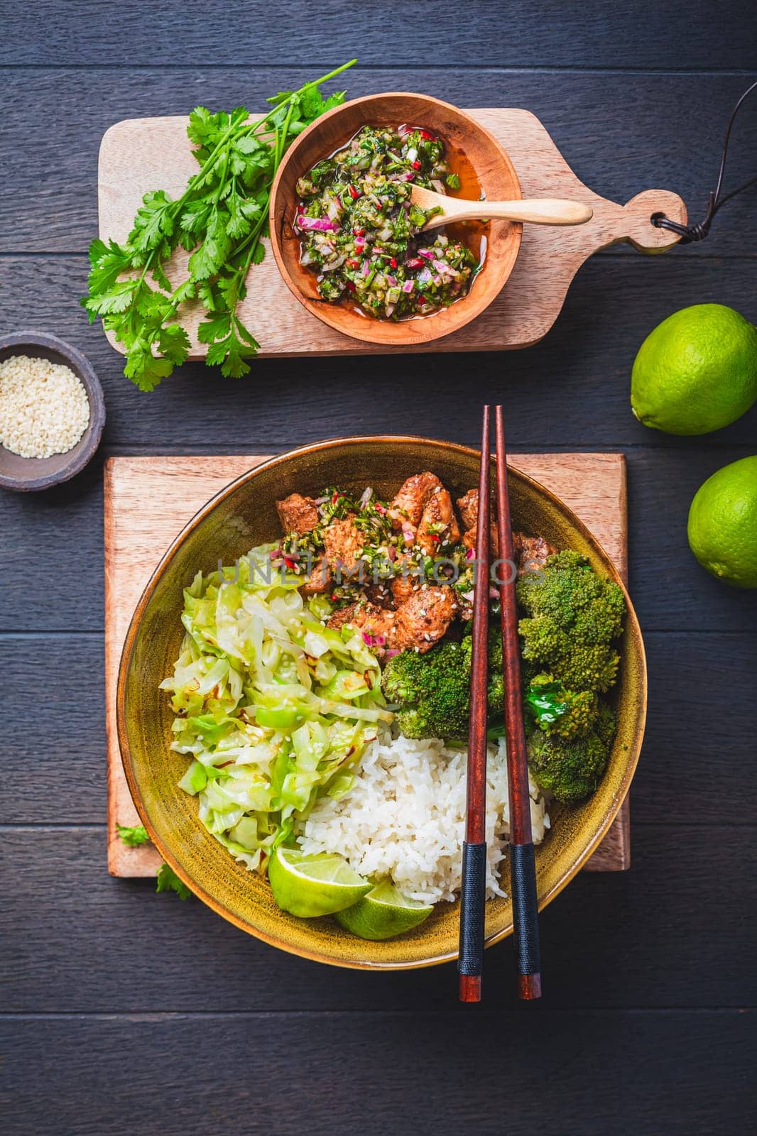 Chicken bowl with rice, broccoli, cabbage and green Chimmichurri salsa