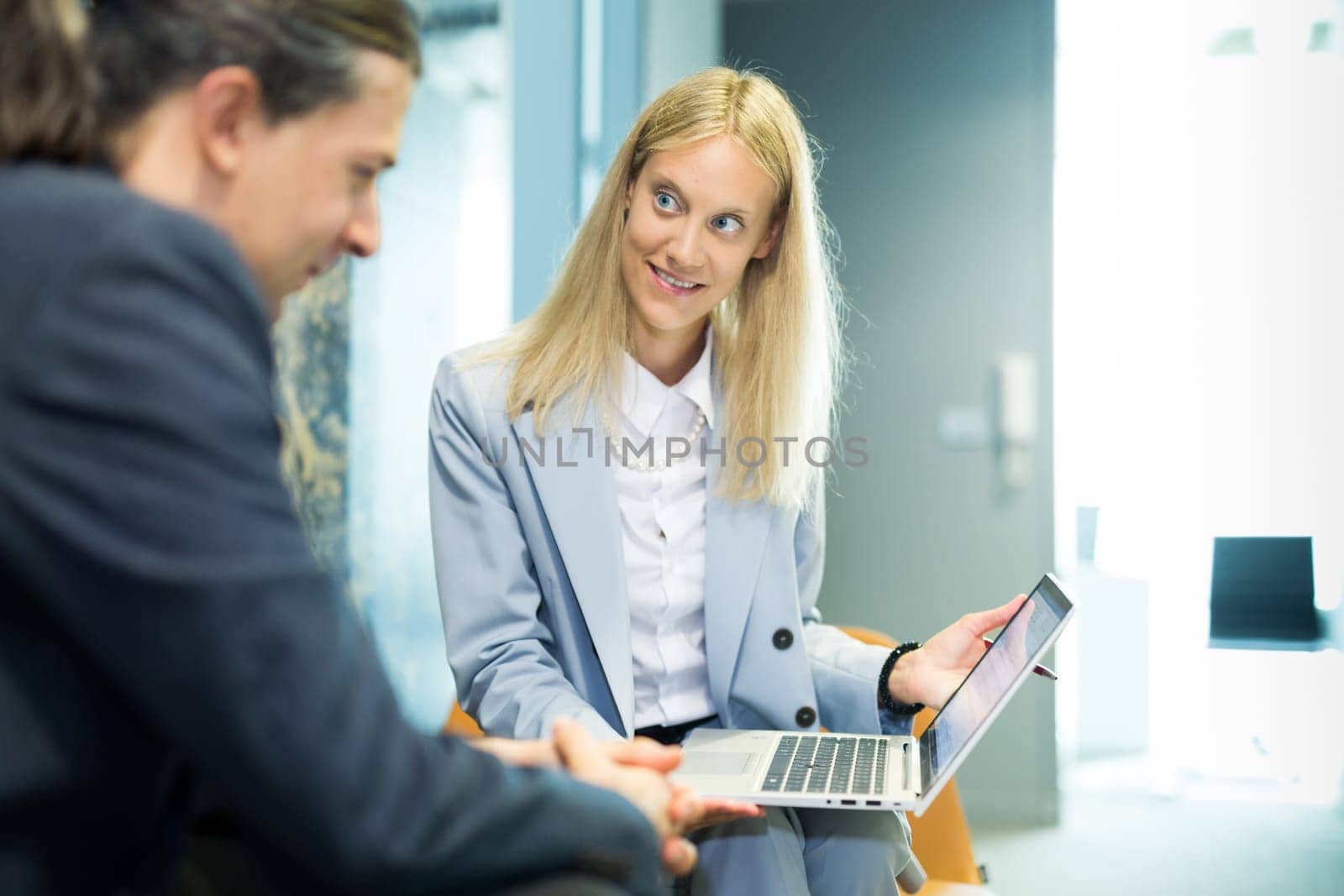 Business meeting. Client consulting. Confident business woman, real estate agent, financial advisor explaining details of project or financial product to client in office