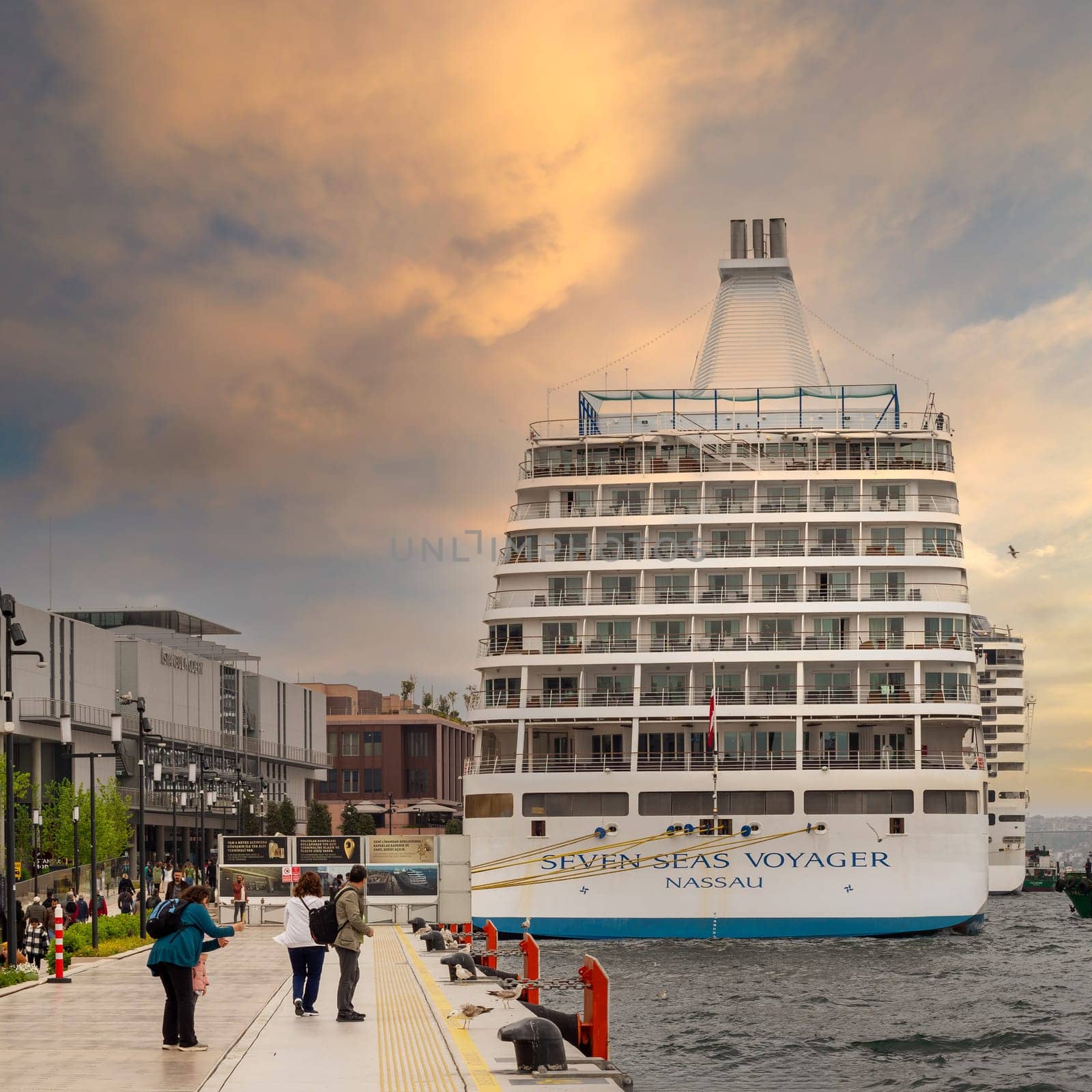 Istanbul, Turkey - May 5, 2023: SEVEN SEAS VOYAGER, Large cruise ship docked at terminal of Galataport, a mixed use development located along shore of Bosphorus, in Karakoy neighbourhood before sunset