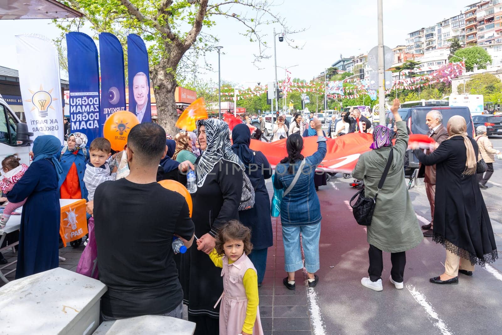 Istanbul, Turkey - May 3 2023: AK Party supporters waving Turkish flag in front of AK Party tent in the neighbourhood of Uskudar during 2023 elections