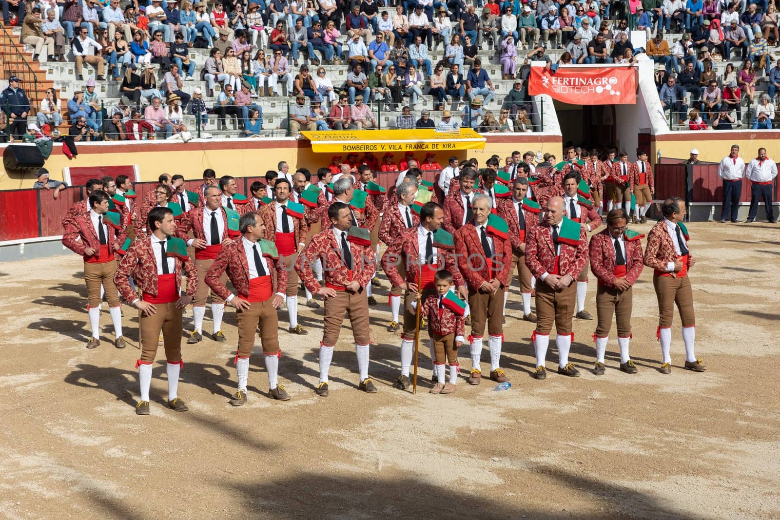 March 26, 2023 Lisbon, Portugal: Tourada - bullfighters in costumes stand in rows on the arena at the opening of the event. Mid shot