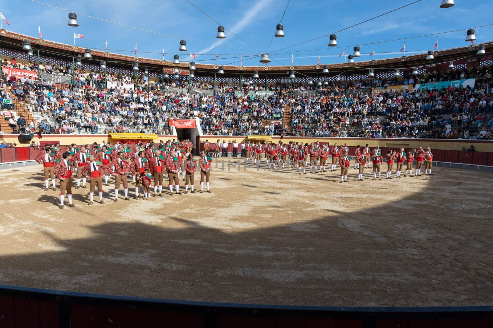March 26, 2023 Lisbon, Portugal: Tourada - bullfighters in costumes stand on the arena at the opening of the event. Mid shot