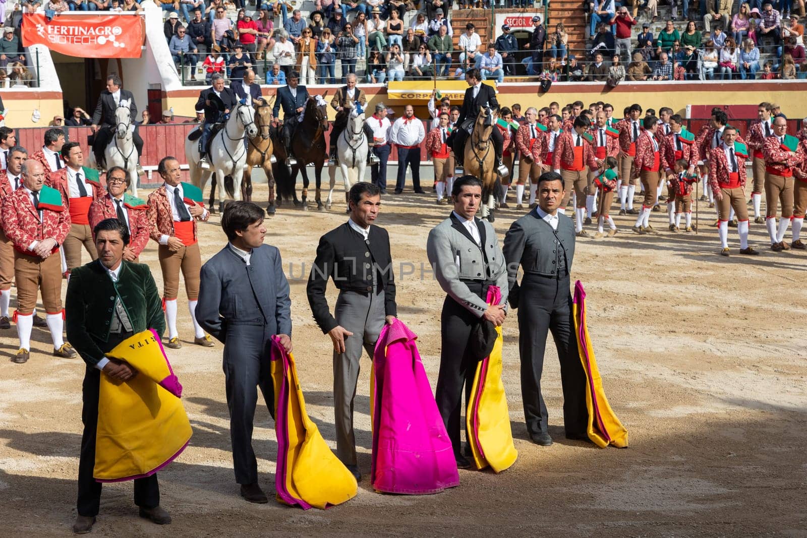 March 26, 2023 Lisbon, Portugal: Tourada - opening of the event - men in grey suits stand with rags for a bull. Mid shot