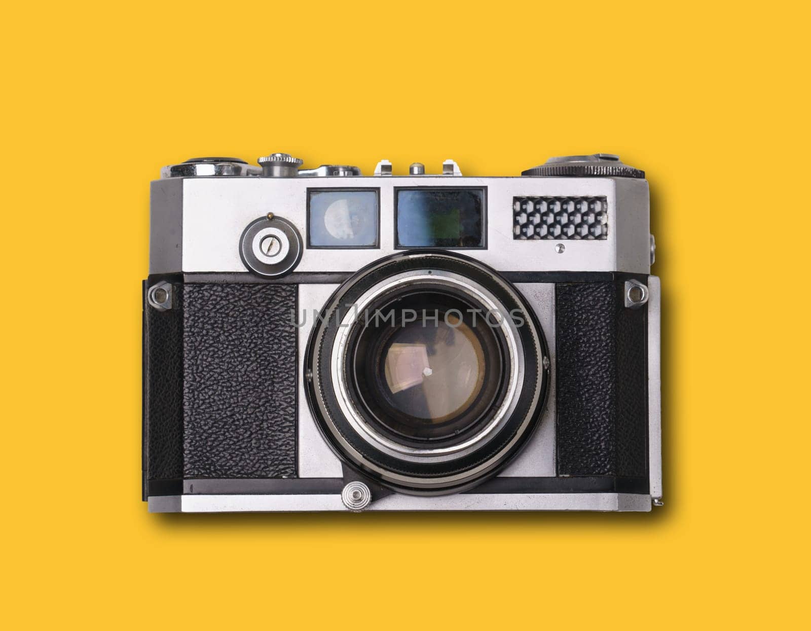 vintage old film camera on yellow background with shadow