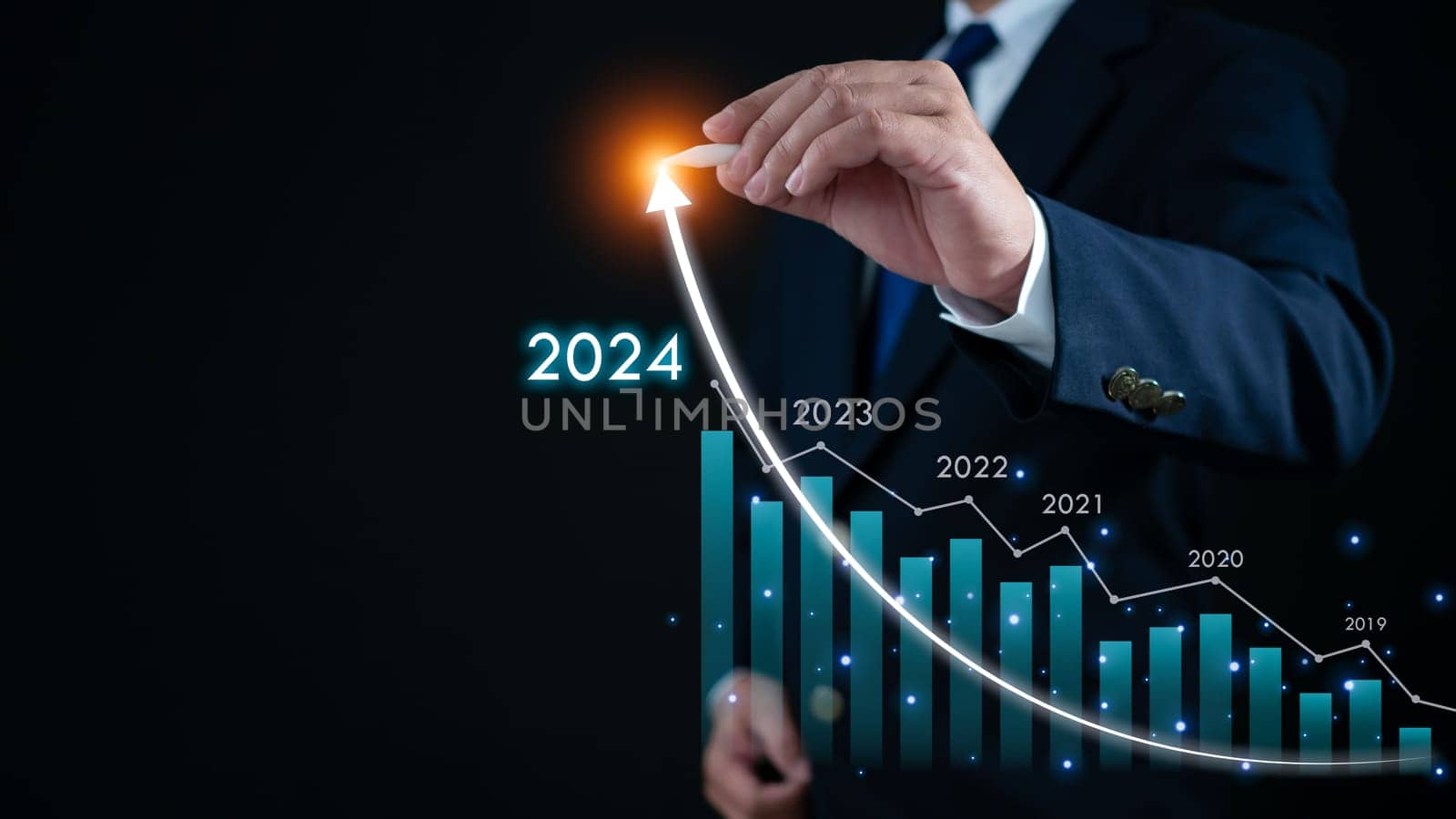 Stock trading. Finance. Investing. Growing business. Businessman in suit pointing with a pen at the tip of an arrow and a graph bar Represents business growth in 2024.