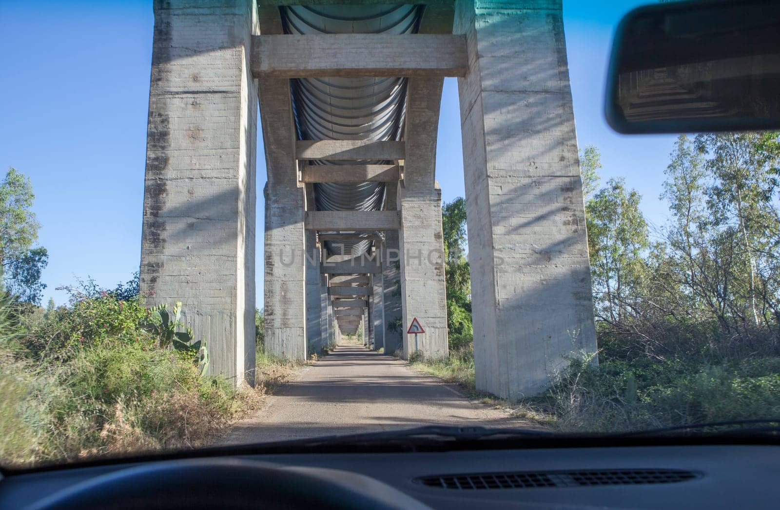 Driving under Acedera Aqueduct. Orellana Irrigation canal, Vegas Altas del Guadiana, Extremadura, Spain