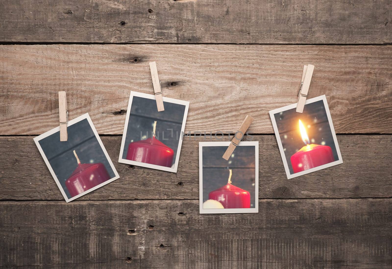 Four old photo frames with Advent candles on a rustic wooden wall, first Advent concept