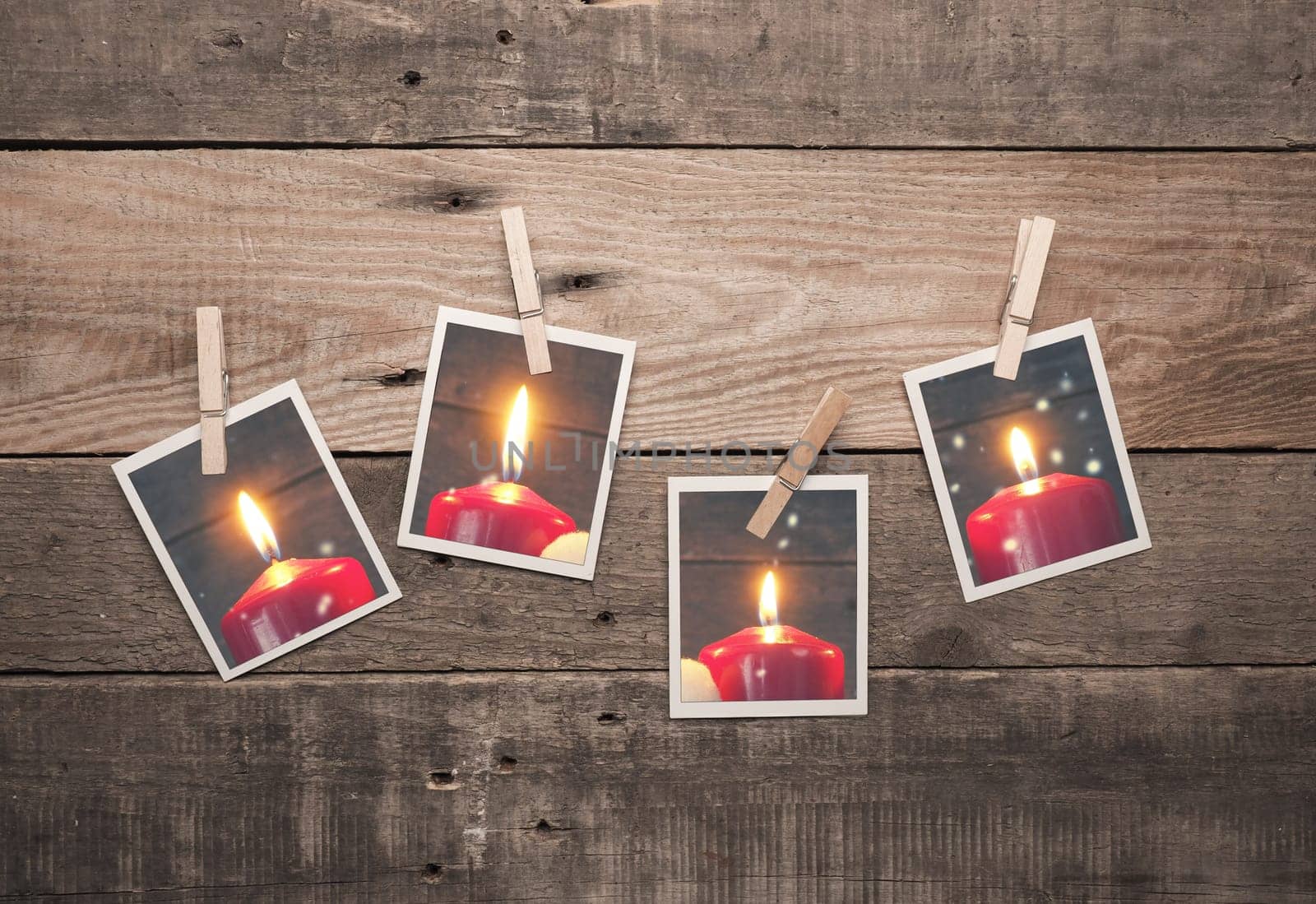 Four old photo frames with Advent candles on a rustic wooden wall, fourth Advent concept