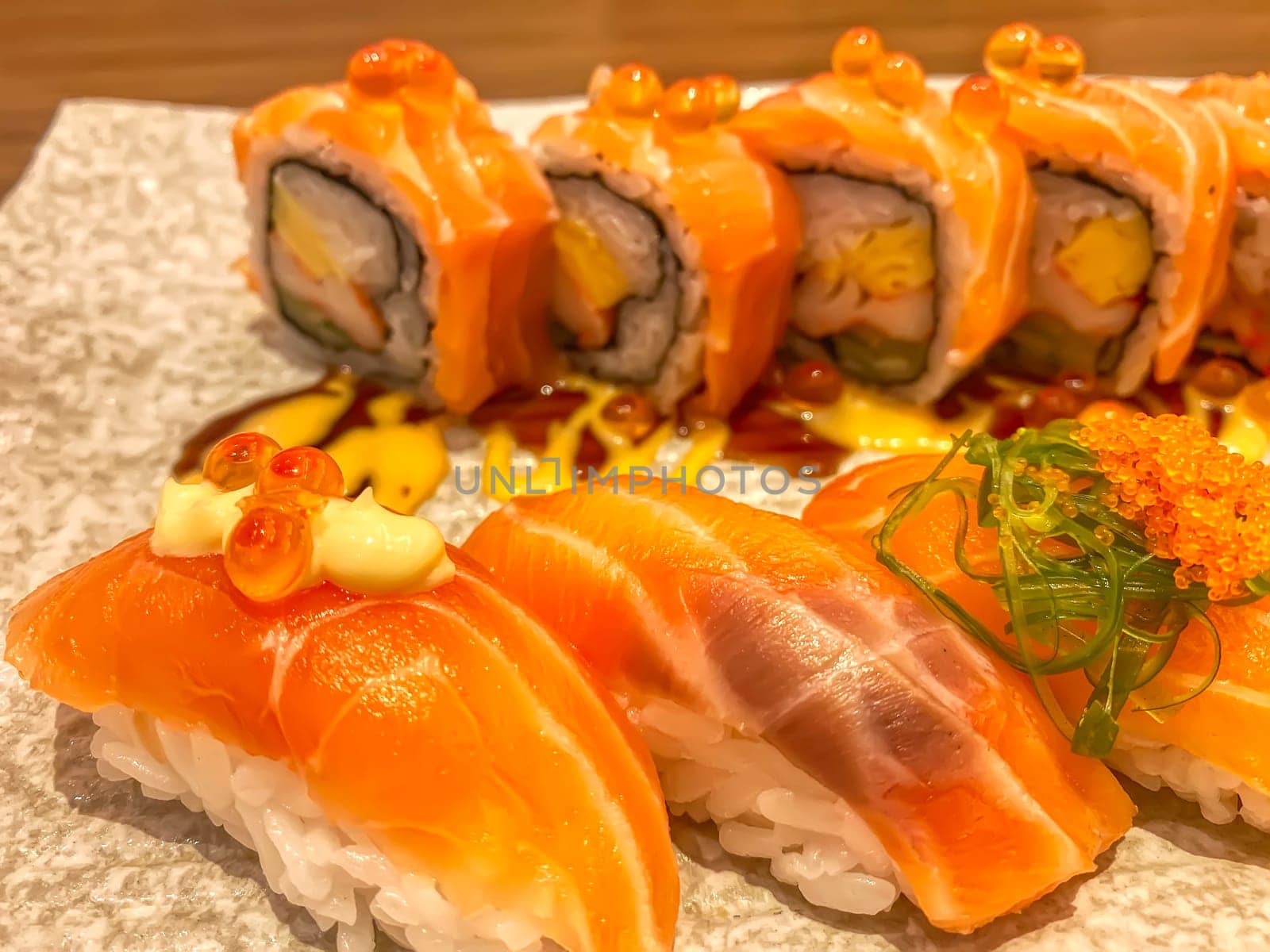 Sashimi sushi in the plate on the wood table. Sushi is a type of food preparation originating in Japan.
