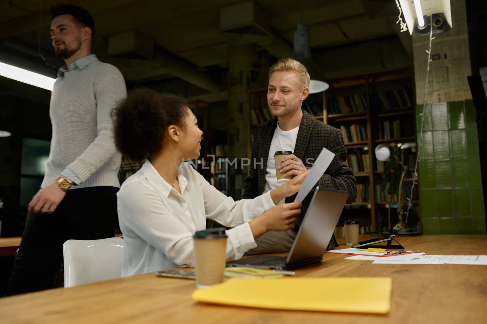 Business people talking and smiling during team meeting in office. Colleagues collaboration concept