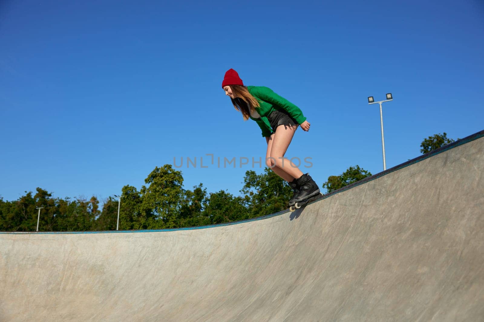 Teenager girl wearing roller blades enjoying extreme sports event. Youth culture, sport and hobby recreation