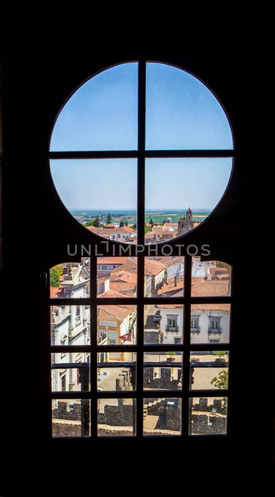 Beja, Portugal - Jul 27th, 2023: Visitors sitting beside interior window bench of the fortress. Beja Castle, Baixo Alentejo, Portugal